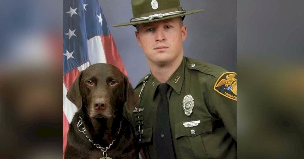 Police officer and dog pose for a professional photo, but these pictures prove that the dog had other plans