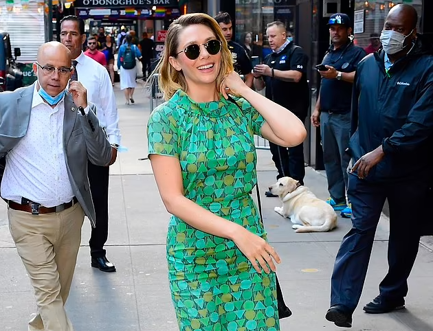 Elizabeth Olsen flashes a wide smile as she arrives at the Good Morning America studios while promoting her new children's book