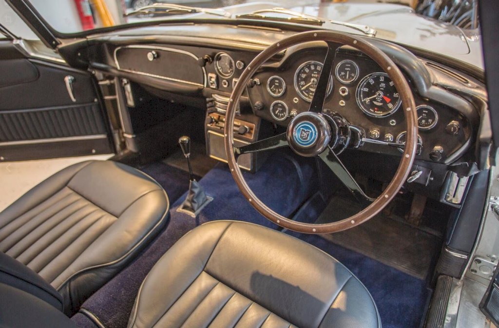 The DB5's interior was a testament to British craftsmanship, with hand-stitched leather upholstery, polished wood veneer, and a comprehensive array of gauges and controls. 