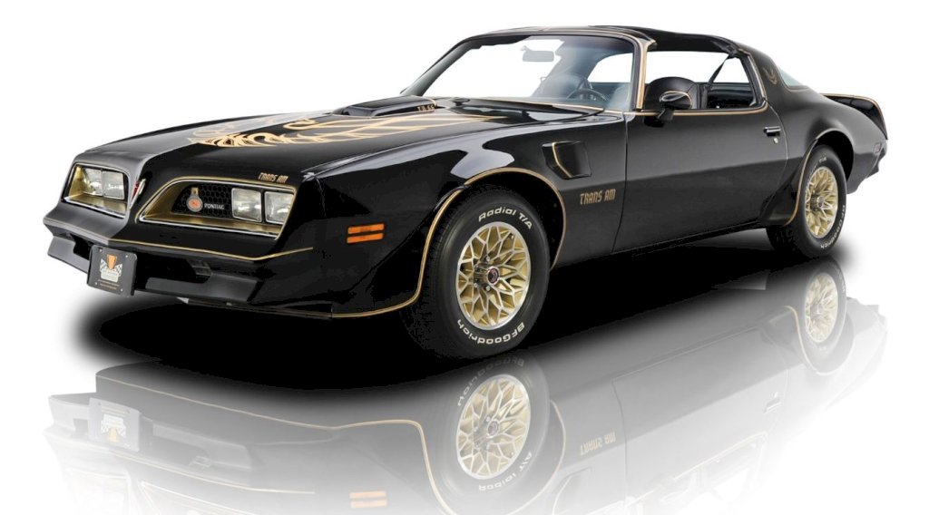 The 1977 Firebird's exterior design is characterized by its long hood, sloping roofline, and short rear deck, which give it an unmistakable muscle car appearance.