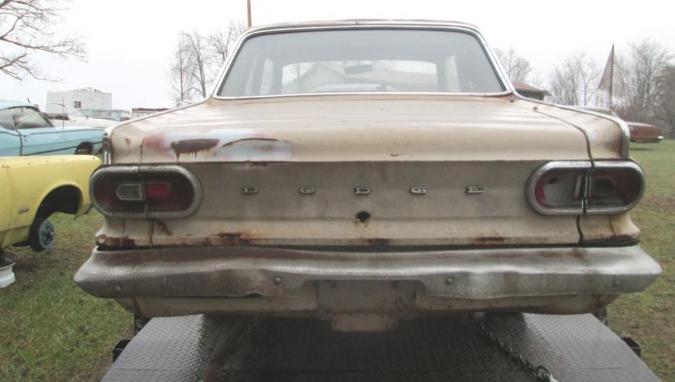 The car's body had suffered from years of neglect, with rust and corrosion eating away at the once-pristine metalwork.